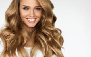 Beautiful Curly Hair. Smiling Girl With Healthy Wavy Long Blonde Hair. Portrait Happy Woman With Beauty Face, Sexy Makeup And Perfect Hair Curls. Volume, Hairstyle, Hairdressing Concept. High Quality